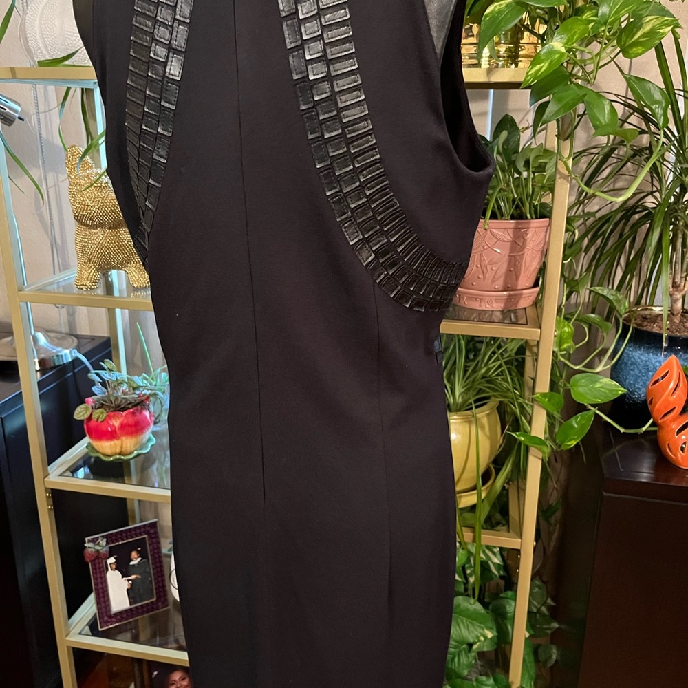 A woman’s black dress in size 12 withFaux leather trim